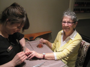 Lynwood Park Resident, Lorna, receiving a manicure during her visit to The Spa Day Retreat in Kanata